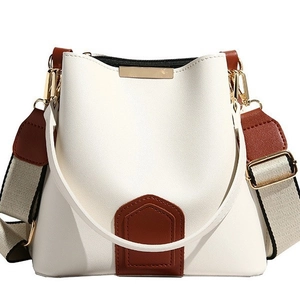 Minimalist vintage bucket bag in white and brown leather with a canvas shoulder strap