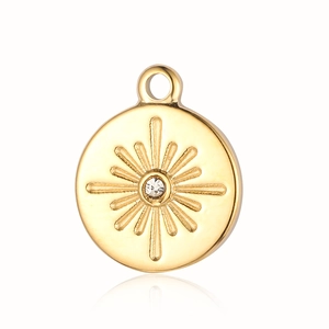 Detailed close-up of golden sunburst pendant with a central sparkling cubic zirconia stone