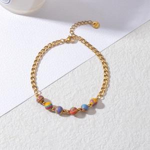 Detailed macro view of 18K gold stainless steel bracelet with colorful marbled resin beads