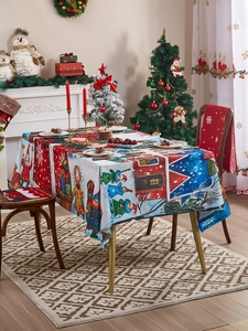 Detail of Christmas tablecloth featuring festive Nordic cartoon houses and snowflake patterns