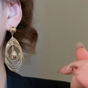 Close-up of 18k gold plated multi-layer water drop earrings on a female model