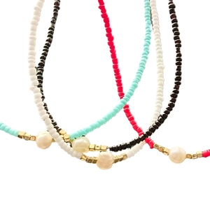 Fashionable handmade necklace featuring colorful seed beads and white freshwater pearls