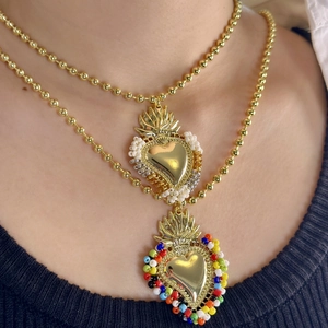 Bohemian layered gold bead necklace with colorful beaded sacred heart pendants