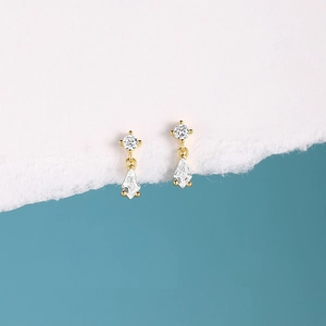 Detailed close-up of S925 silver geometric drop earrings with sparkling zircon crystals