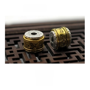 Detail of 11mm two-tone spinning Buddhist mantra beads for bracelet making