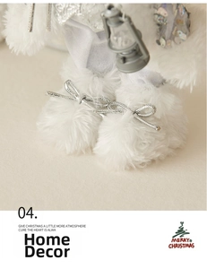 Detail view of plush white faux fur feet on Santa doll with silver ribbon bows