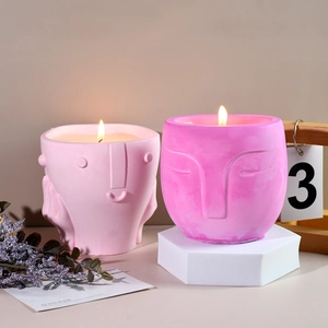 Abstract face relief scented candle pot with matte texture in pink and purple colors