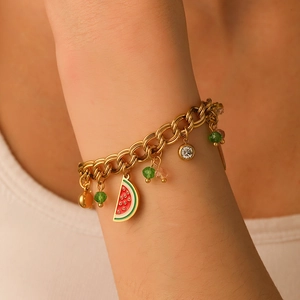 Golden stainless steel chain bracelet with watermelon charm and colorful beads on wrist