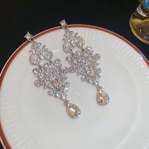 Elegant teardrop chandelier earrings with sparkling crystals in baroque silver finish