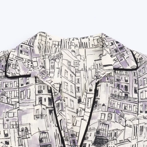 Women's V-neck shirt featuring architectural prints and black contrast piping detail