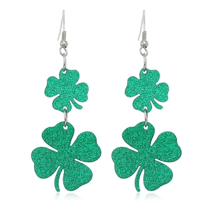Detailed view of green glitter shamrock dangle earrings with tiered clover design