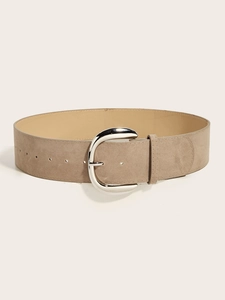 Detail of wide khaki suede belt with large silver metal buckle and soft texture