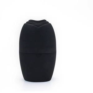 Detail of black silicone ice roller showing the rose petal textured top and matte finish