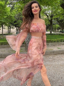 Detail of floral print off-shoulder cropped top and high waist maxi skirt in pink tulle