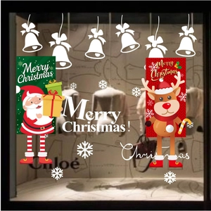 Detail of Christmas window stickers featuring Santa, reindeer and snowflakes on glass