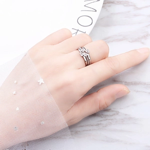 Close-up of multilayer silver hollow ring with heart pattern and sparkling crystals