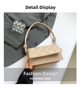 Close-up of beige quilted crossbody bag with unique knot shoulder strap and gold hardware