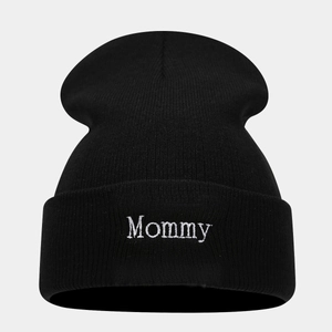 Close-up of high-quality Mommy embroidery on the cuff of a black ribbed knit beanie