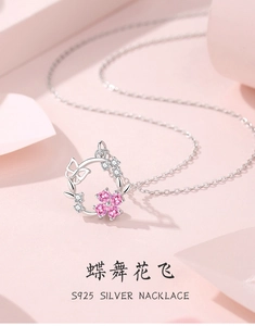 Macro detail of S925 silver necklace featuring a pink flower and镂空 butterfly pendant