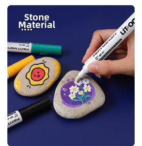 Vibrant oil-based paint markers showing opaque color application on natural stone surfaces