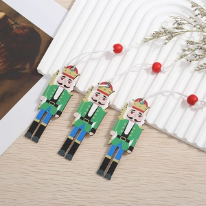 Detailed view of three hand-painted wooden nutcracker soldiers with hanging ropes