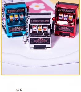 Detailed view of three mini lucky slot machine keychains in blue, silver, and red colors