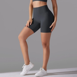 Detail of high-waisted dark grey yoga shorts with seamless front and compression fabric