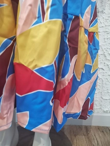 Detail of colorful geometric print and plain weave fabric texture on a summer dress