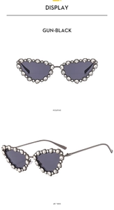 Detail of gun-black metal cat eye sunglasses with butterfly frame and rhinestones