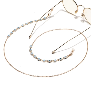 Golden metal eyewear chain featuring blue evil eye beads and non-slip silicone hooks