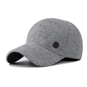 Close-up of dark grey knitted baseball cap featuring a textured fabric and 'M' logo