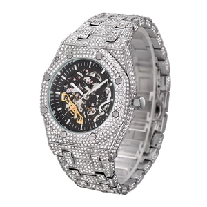 Macro shot of iced out skeleton mechanical watch with clear crystals and silver gears