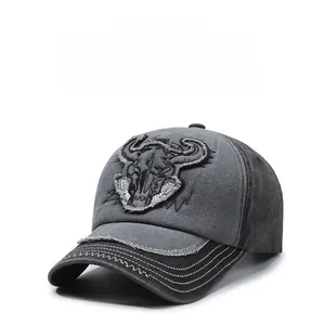 Detail of embroidered bull skull and distressed stitching on a vintage baseball cap