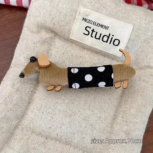 Detail of 10cm dachshund hair claw made of brown corduroy and polka dot fabric