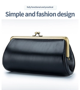 Close-up of black leather evening clutch with elegant gold metal frame and clasp
