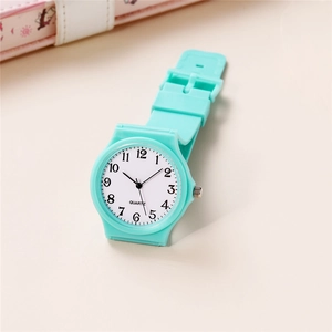 Detail of mint green quartz watch with soft silicone strap and clear numeric dial face