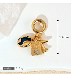 Detail of gold world map, airplane, and passport pendant with zircon inlay and measurements