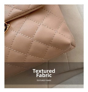 Close-up of beige quilted crossbody bag showing premium textured fabric and stitching