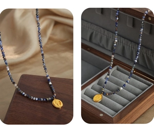 Detailed view of natural stone beaded necklace with vintage oval relief portrait pendant