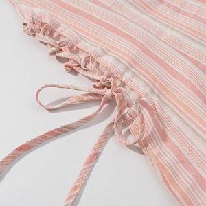 Close-up detail of pink and white striped fabric with side lace-up drawstring design