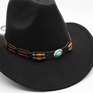 Close-up of black wool felt fedora featuring a vintage turquoise and leather decorative band