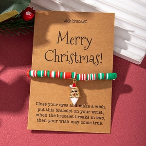 Christmas wish bracelet with red green polymer clay beads and Santa Claus charm on card