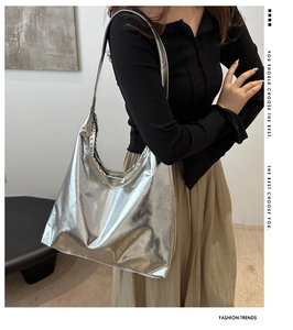 Close-up of metallic silver oversized hobo bag showing high-gloss texture on shoulder