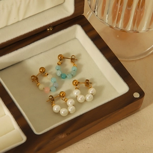 Boucles d'oreilles en perles baroques et perles colorées dans un coffret à bijoux en bois