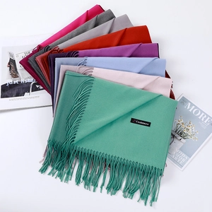 Close-up of soft cashmere scarf textures with elegant fringe in multiple vibrant colors