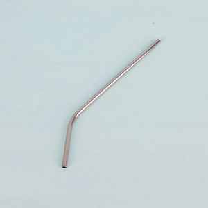 Close-up of a rose gold curved stainless steel straw for coffee tumblers