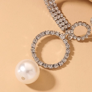 Luxury silver necklace with large white pearl and geometric pavé diamond circles