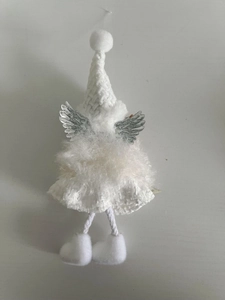 Close-up of white knitted Christmas angel ornament with silver wings and plush skirt