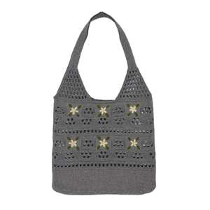 Grey knit hollow-out tote bag with yellow daisy embroidery on a white background