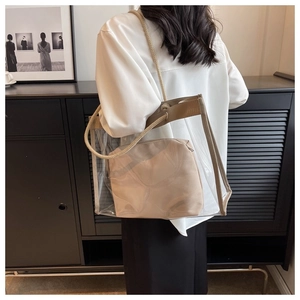 Detail of transparent PVC tote with beige inner pouch and woven hemp rope straps